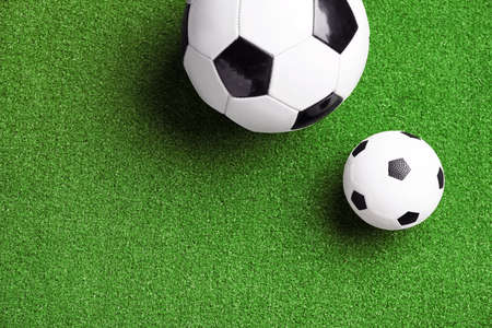 Soccer balls on green fieldの写真素材