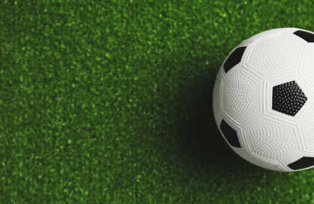 Soccer ball on green fieldの写真素材