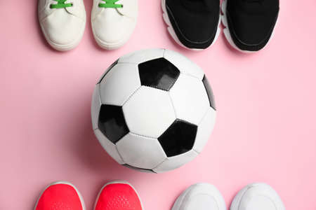 Soccer ball and shoes on color backgroundの写真素材