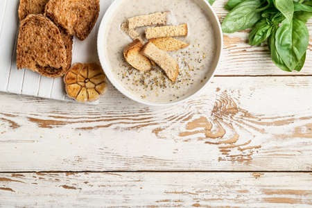 Bowl of tasty cream soup on wooden backgroundの写真素材