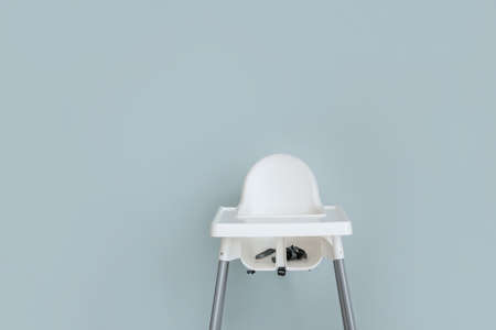 Baby highchair on color background