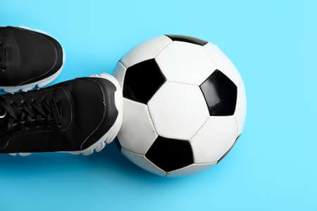 Soccer ball and shoes on color backgroundの写真素材