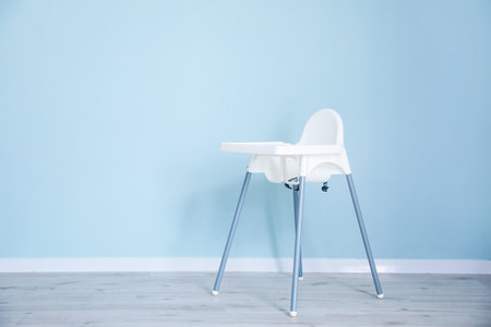 Baby highchair on color backgroundの写真素材