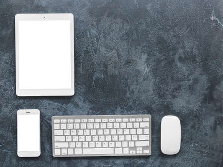 Modern tablet computer, PC keyboard, mouse and smartphone on table