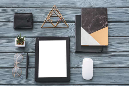 Composition with tablet computer, mouse and stationery on wooden backgroundの写真素材