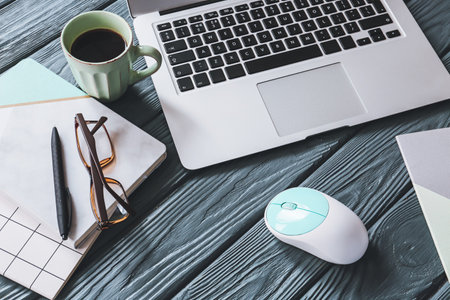 Composition with laptop, mouse and stationery on wooden backgroundの写真素材