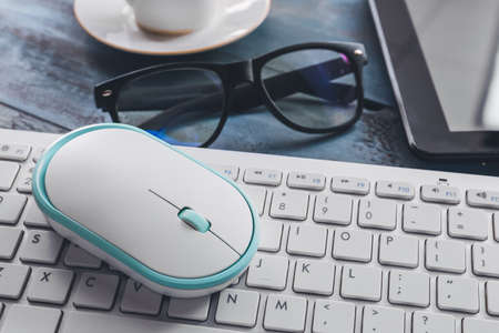 Modern PC mouse and keyboard on table, closeup