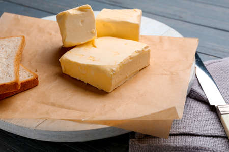 Delicious butter and bread on wooden table