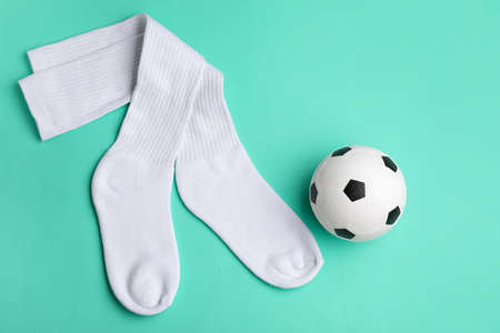 Soccer ball and socks on color backgroundの写真素材