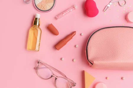 Composition with cosmetic bag on color background
