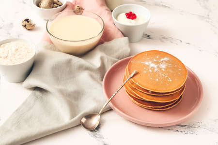 Tasty pancakes with ingredients on white backgroundの写真素材
