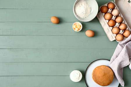 Tasty pancakes with ingredients on tableの写真素材