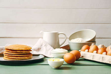 Tasty pancakes with ingredients on tableの写真素材