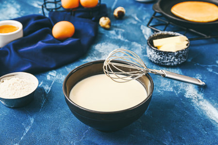 Fresh dough for pancakes on color background