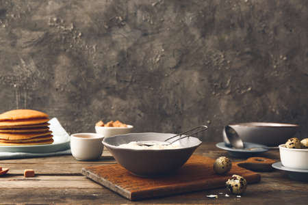 Bowl with flour for pancakes on table