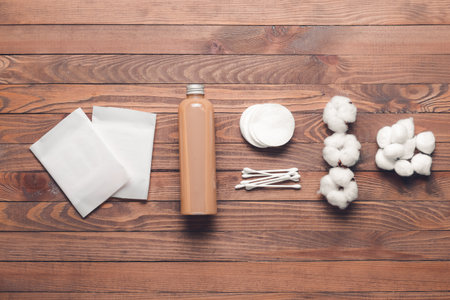 Cotton flowers with supplies and cosmetics on wooden backgroundの写真素材
