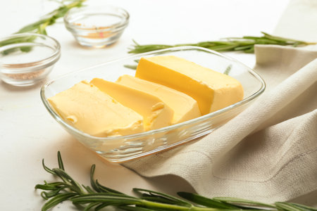 Fresh butter and rosemary on light backgroundの写真素材