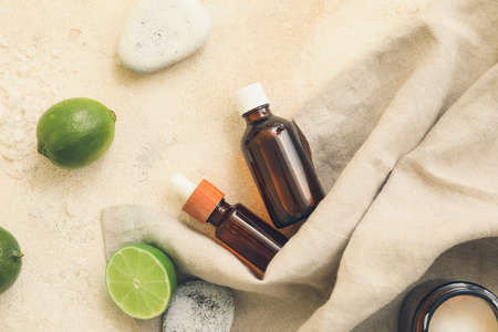 Composition of bottles with natural citrus cosmetics on light backgroundの写真素材