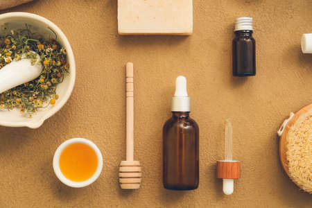 Composition of bottles with natural cosmetics and bath supplies on color backgroundの写真素材