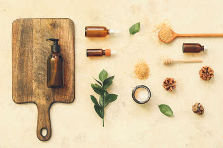 Composition of bottles with natural cosmetics on light background