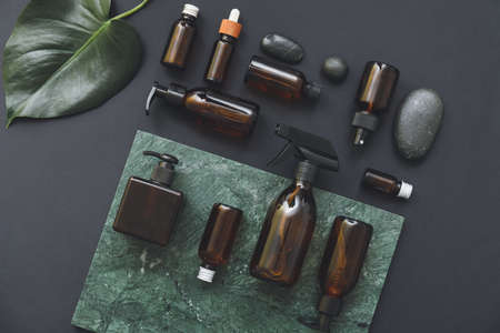 Composition with cosmetic bottles on dark backgroundの写真素材