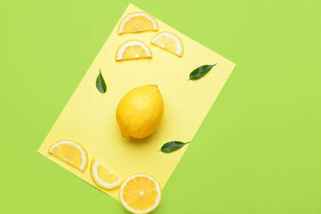 Composition with ripe lemons on color background