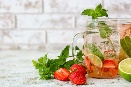 Mason jar of tasty strawberry mojito on tableの写真素材