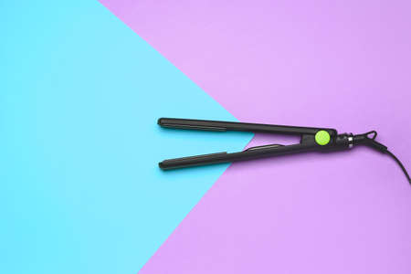 Straightening iron on color backgroundの写真素材