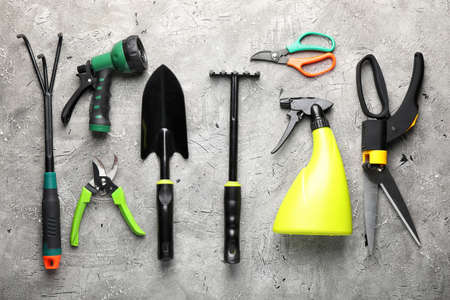 Gardening tools on gray background