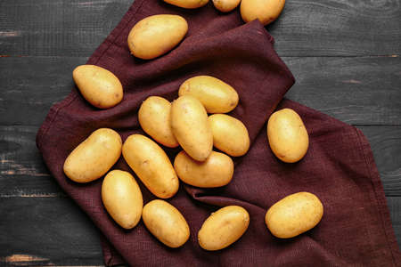 Raw potatoes on wooden tableの写真素材