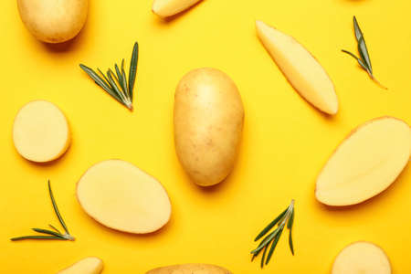 Raw potatoes on color backgroundの写真素材