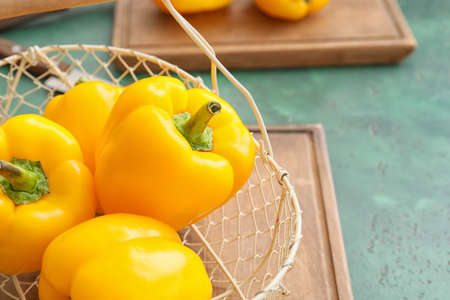Yellow bell pepper in basket on tableの写真素材