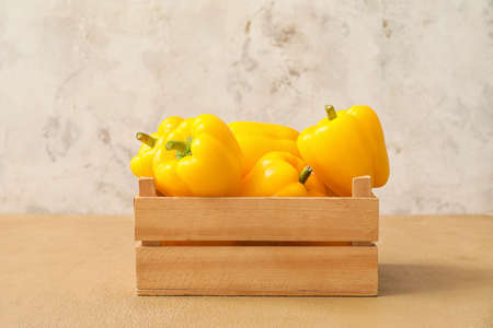 Yellow bell pepper in box on table