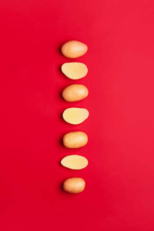 Raw potatoes on color background