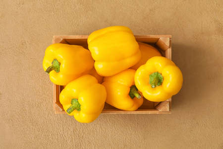 Yellow bell pepper in box on tableの写真素材