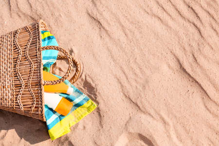 Bag with sunscreen cream on beachの写真素材