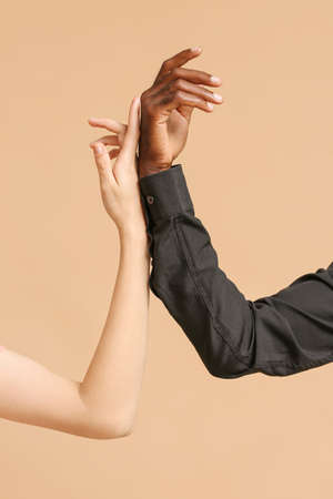 Hands of Caucasian woman and African-American man on color background. Racism conceptの写真素材