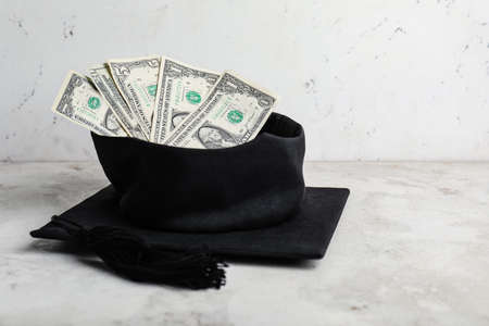 Graduation hat with money on table. Tuition fees conceptの写真素材