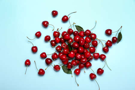 Ripe sweet cherry on color background