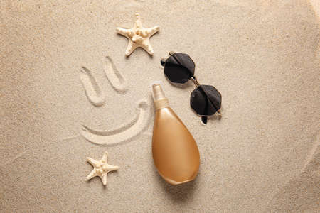 Composition with sunscreen cream on sand