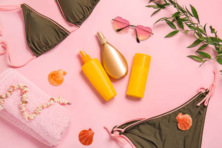 Beach accessories with sunscreen cream on color backgroundの写真素材