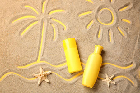 Composition with sunscreen cream on sandの写真素材