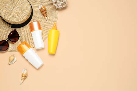Beach accessories with sunscreen cream on color backgroundの写真素材