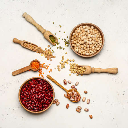 Different raw legumes on white background