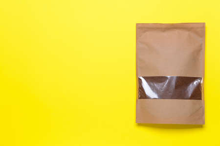 Bag with coffee powder on color backgroundの写真素材