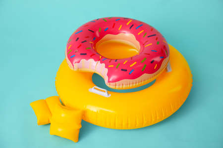 Inflatable rings and arm floats on color backgroundの写真素材