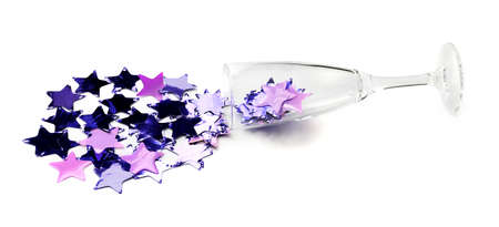 Champagne glass with confetti on white backgroundの写真素材