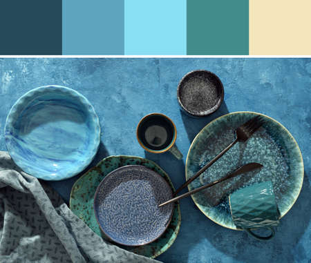Stylish tableware on blue background. Different color patternsの写真素材