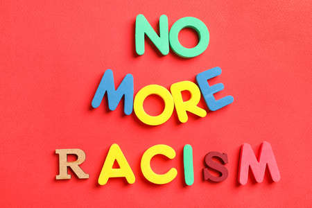 Text NO MORE RACISM on color background