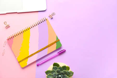 Composition with notebook on color background